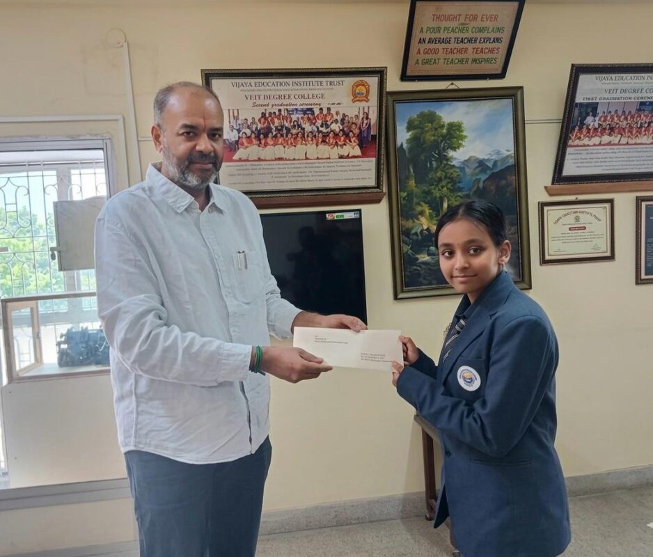 Trustee Mr. K.H. Radharaman presenting higher education scholarships to students at Vijaya English Primary School.