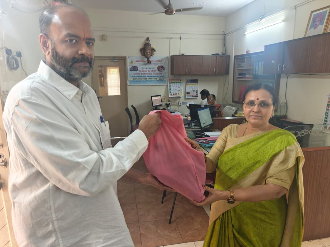 Founding Trustee Mr. K.H. Radharaman handing over essential cleaning supplies to Amrutha Shishu Nivasa for Angadi Foundation and House of Angadi.
